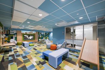 A room with a blue ceiling and a colorful floor.